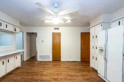 a view of a kitchen with a refrigerator and a sink