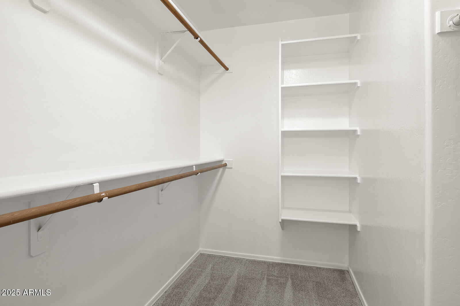 3297 East Warbler Road Gilbert, AZ 85297 - Photo 19 of 32 a view of an empty walk in closet