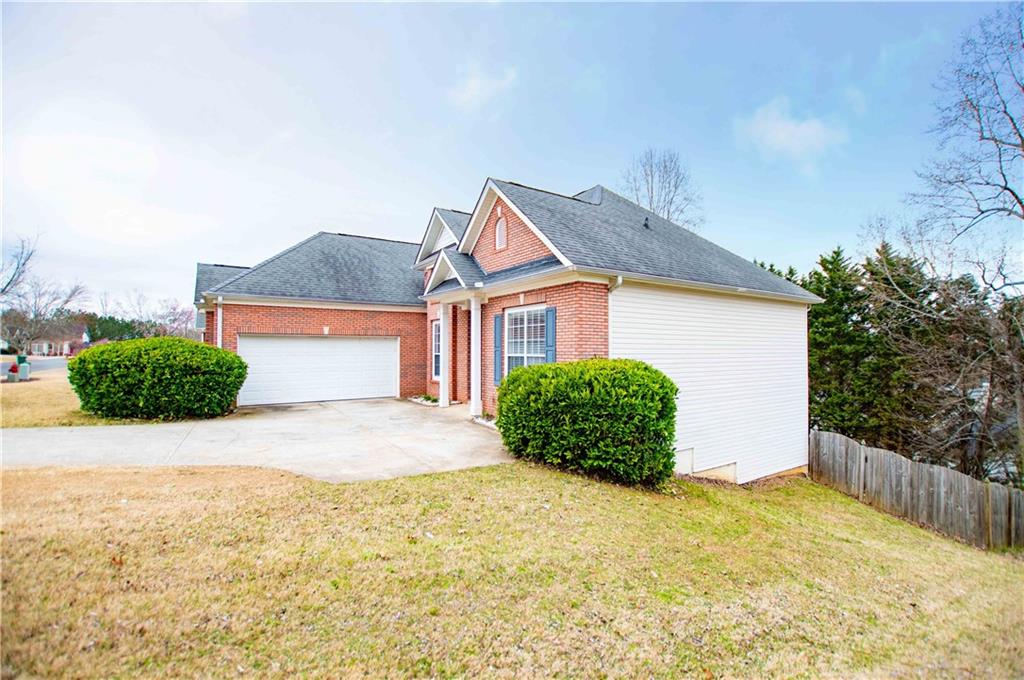 2657 Neighborhood Walk Villa Rica, GA 30180 - Photo 2 of 81 a front view of a house with a yard and garage