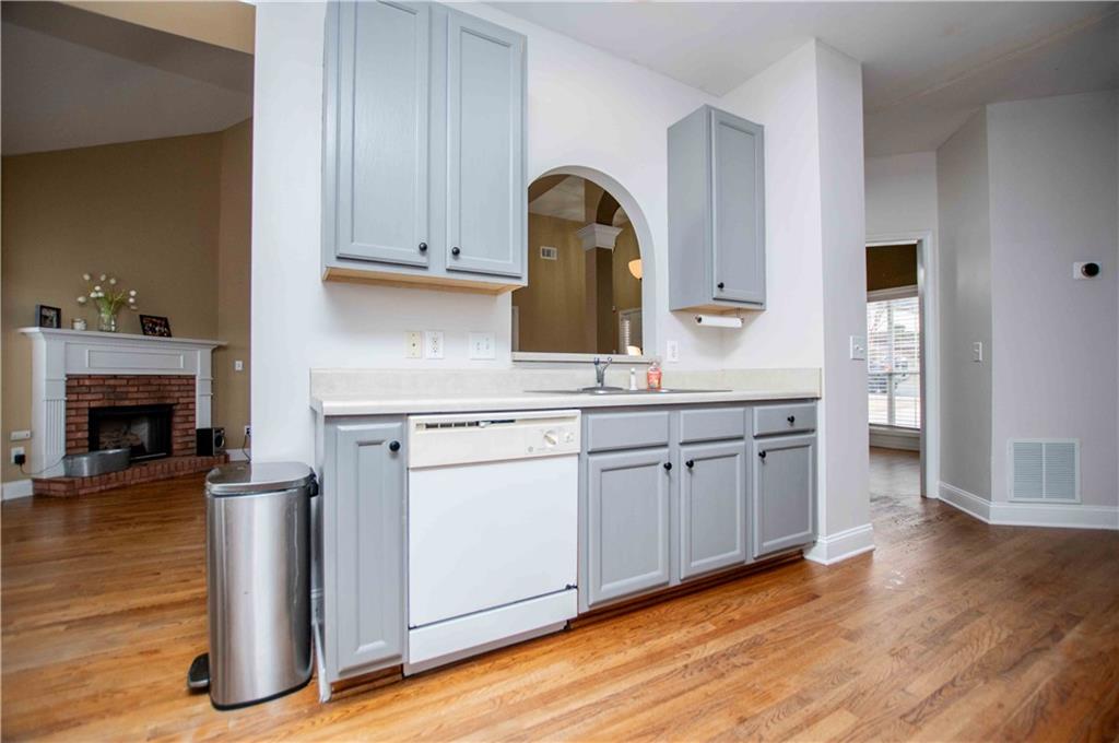 2657 Neighborhood Walk Villa Rica, GA 30180 - Photo 25 of 81 a kitchen with a sink cabinets and wooden floor