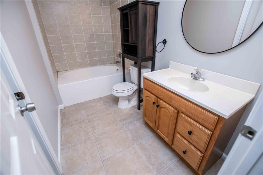 2657 Neighborhood Walk Villa Rica, GA 30180 - Photo 64 of 81 a bathroom with a sink a toilet and a mirror