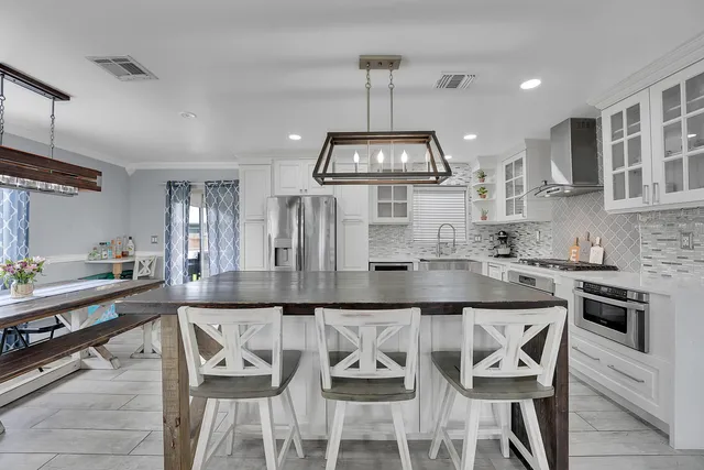 a kitchen with granite countertop kitchen island cabinets and stainless steel appliances