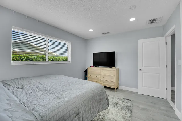 a bedroom with a bed and a television