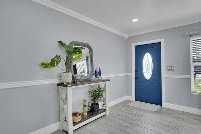 a room with painting on the wall and a potted plant