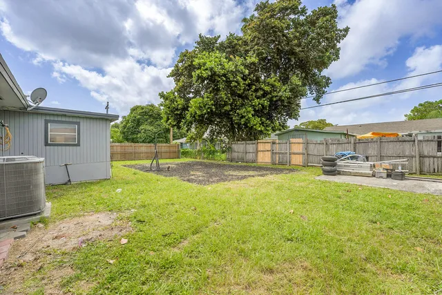 a view of a house with pool and a yard