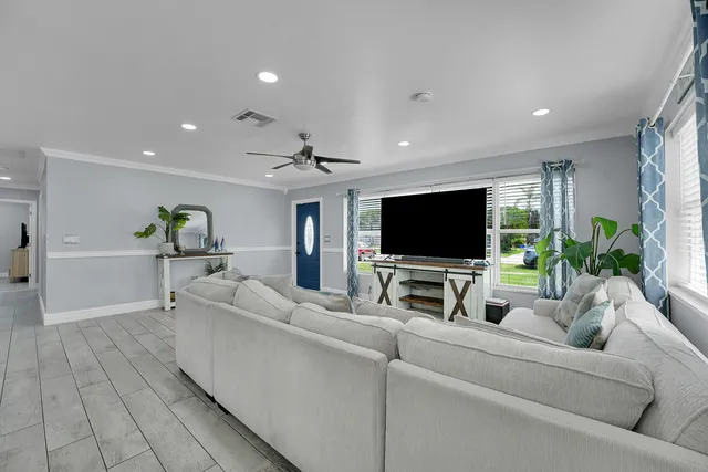 a living room with furniture and a flat screen tv