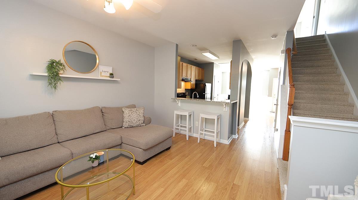7626 Winners Edge Street Raleigh, NC 27617 - Photo 11 of 20 a living room with furniture and a wooden floor