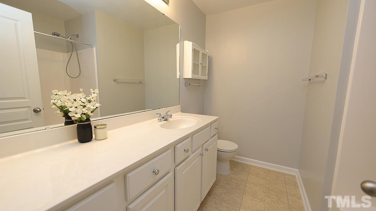 7626 Winners Edge Street Raleigh, NC 27617 - Photo 14 of 20 a bathroom with a sink toilet and shower