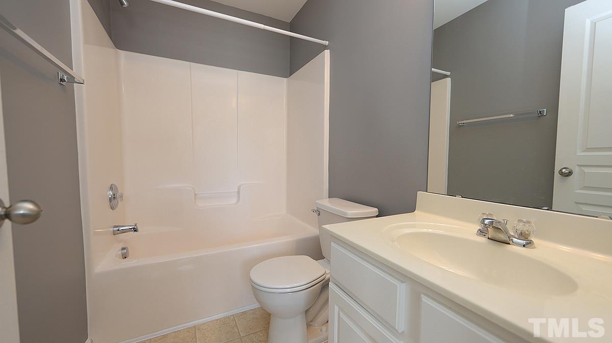 7626 Winners Edge Street Raleigh, NC 27617 - Photo 17 of 20 a bathroom with a sink toilet and shower