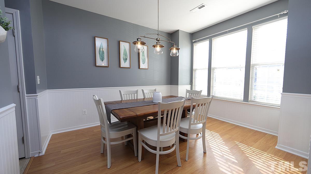 7626 Winners Edge Street Raleigh, NC 27617 - Photo 3 of 20 a view of a dining room with furniture window and wooden floor