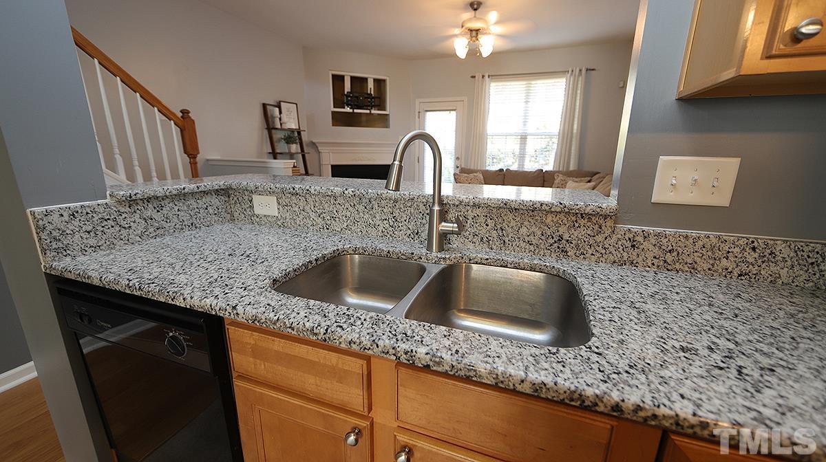 7626 Winners Edge Street Raleigh, NC 27617 - Photo 5 of 20 a kitchen with granite countertop a sink and a granite counter top