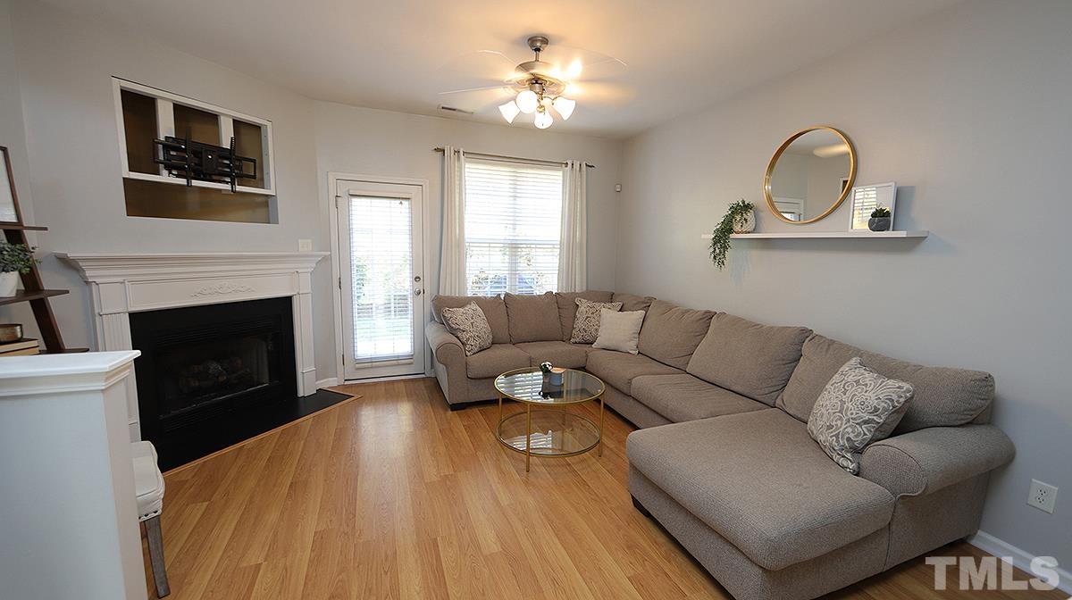 7626 Winners Edge Street Raleigh, NC 27617 - Photo 8 of 20 a living room with furniture and a fireplace