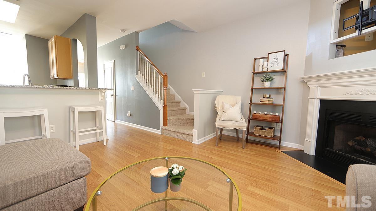 7626 Winners Edge Street Raleigh, NC 27617 - Photo 9 of 20 a living room with furniture and a fireplace