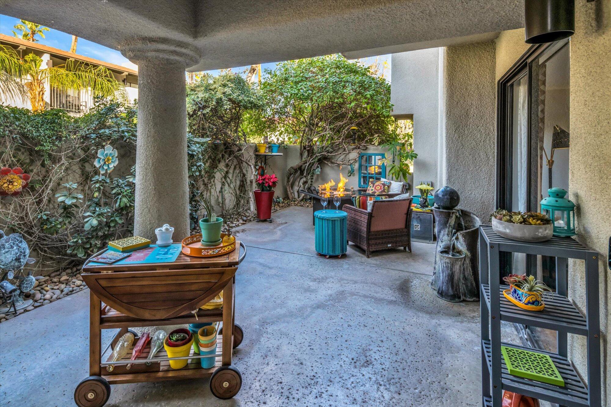 1100 East Amado Road, Unit 12B1 Palm Springs, CA 92262 - Photo 1 of 29 a patio with patio table and chairs