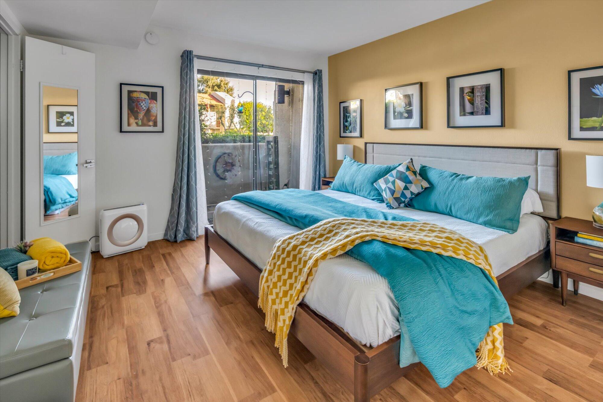 1100 East Amado Road, Unit 12B1 Palm Springs, CA 92262 - Photo 15 of 29 a bedroom with a bed and wooden floor
