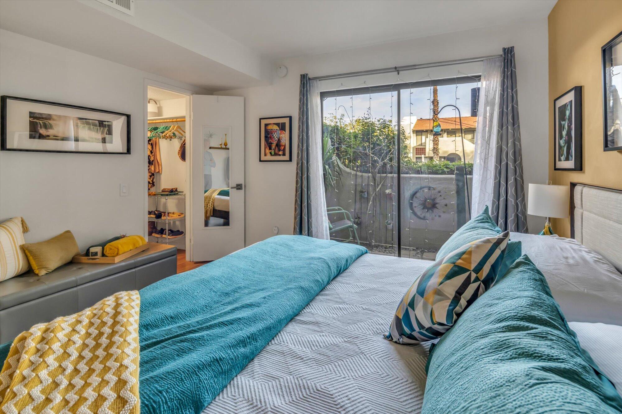 1100 East Amado Road, Unit 12B1 Palm Springs, CA 92262 - Photo 18 of 29 a bedroom with a bed and wooden floor