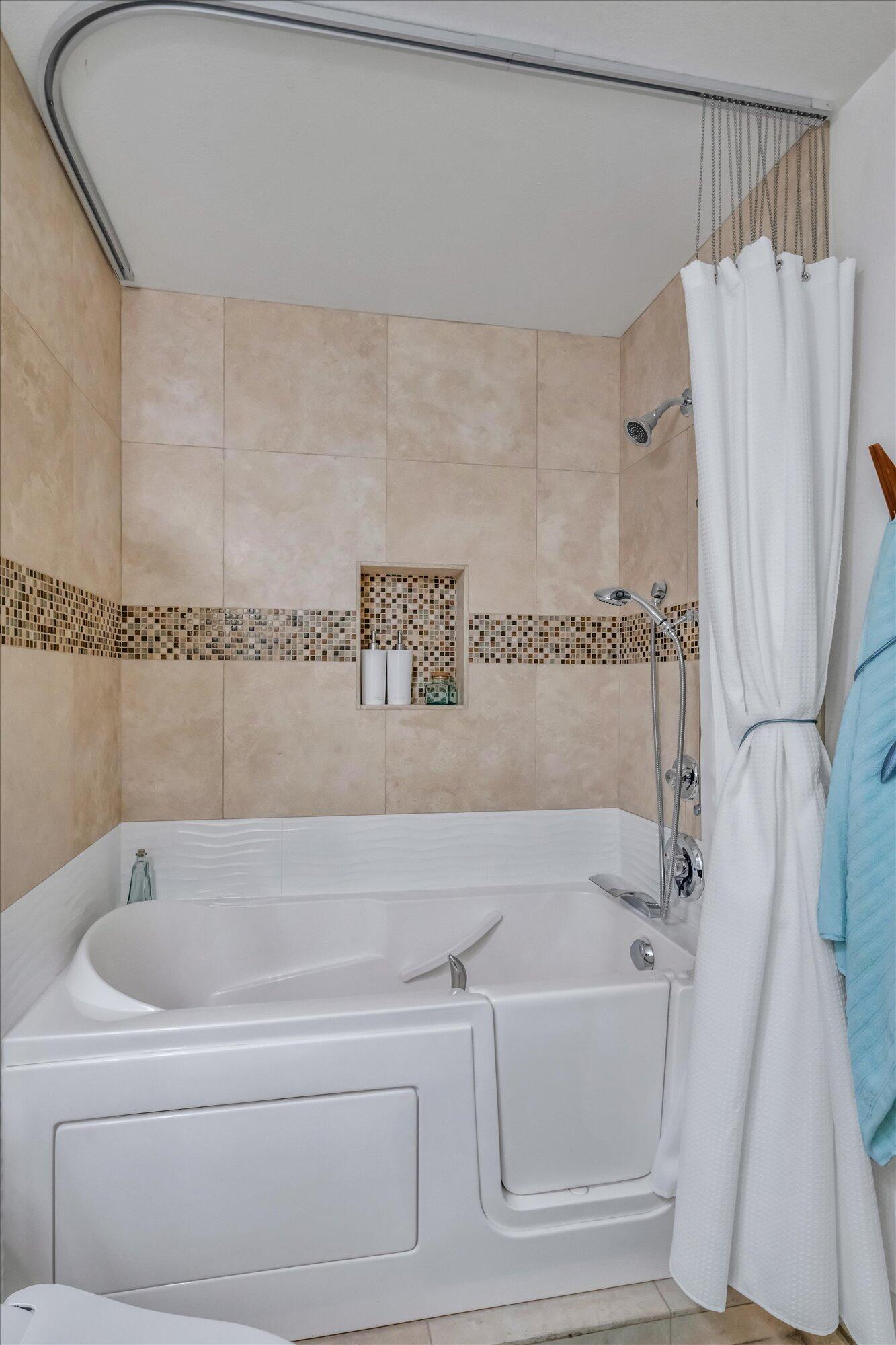 1100 East Amado Road, Unit 12B1 Palm Springs, CA 92262 - Photo 22 of 29 a bathroom with a bathtub and a shower