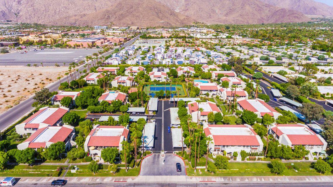 1100 East Amado Road, Unit 12B1 Palm Springs, CA 92262 - Photo 26 of 29 an aerial view of residential houses with outdoor space and parking