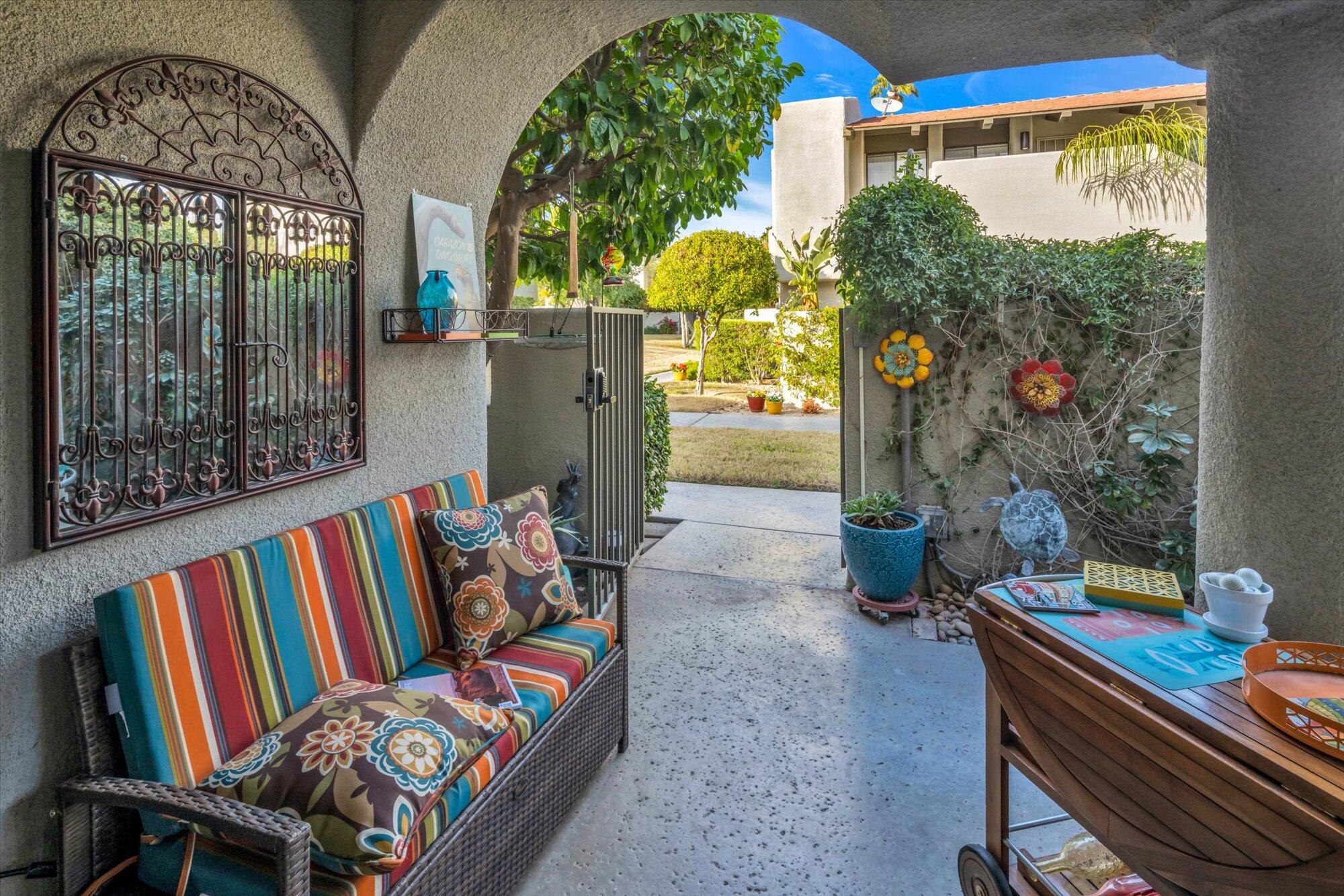 1100 East Amado Road, Unit 12B1 Palm Springs, CA 92262 - Photo 3 of 29 a living room filled with lots of furniture and a book