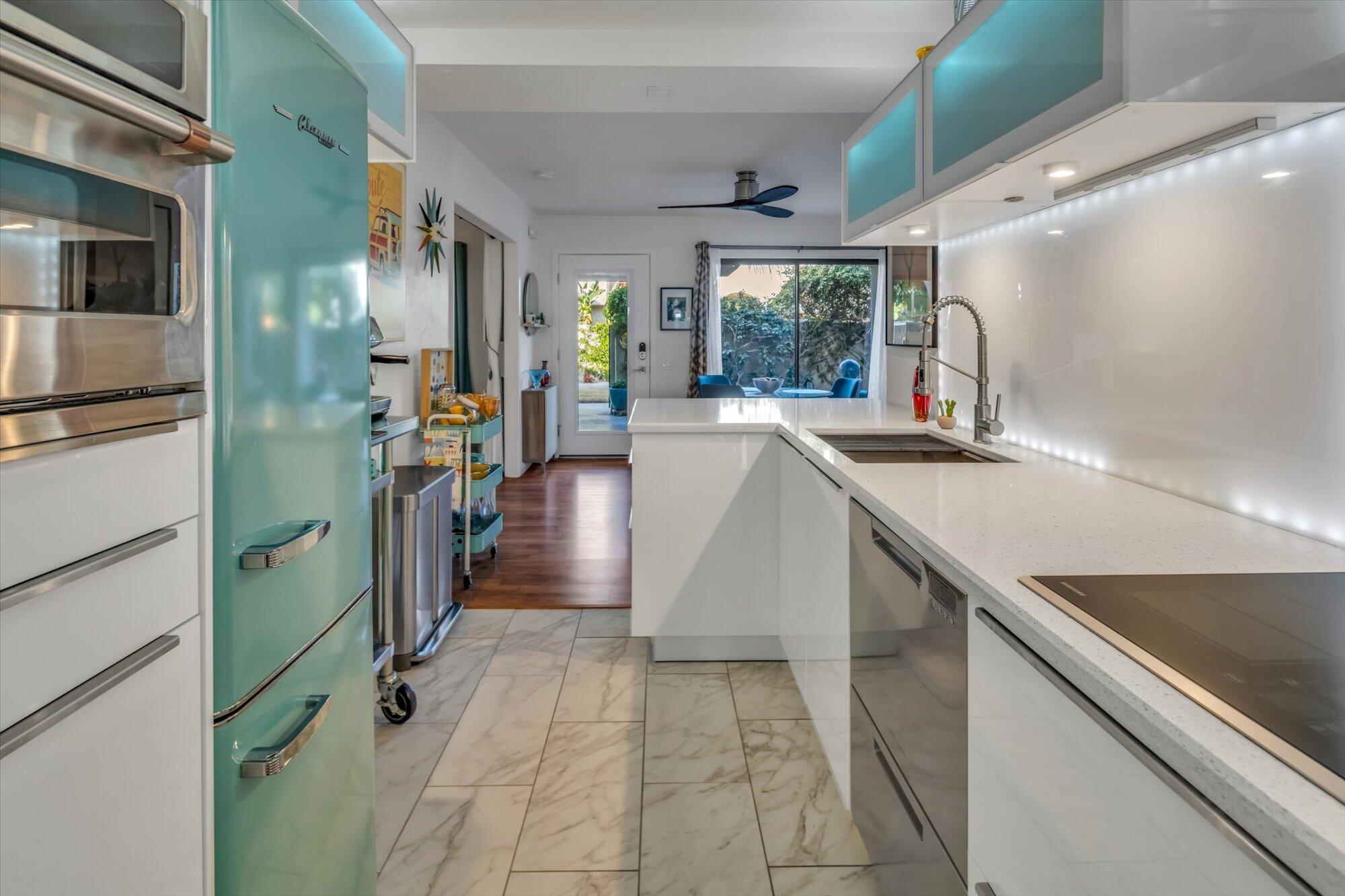 1100 East Amado Road, Unit 12B1 Palm Springs, CA 92262 - Photo 7 of 29 a kitchen with sink a counter top space and stainless steel appliances