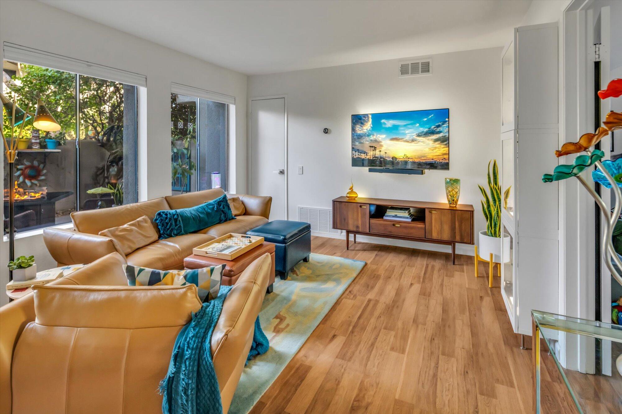 1100 East Amado Road, Unit 12B1 Palm Springs, CA 92262 - Photo 10 of 29 a living room with furniture and a flat screen tv