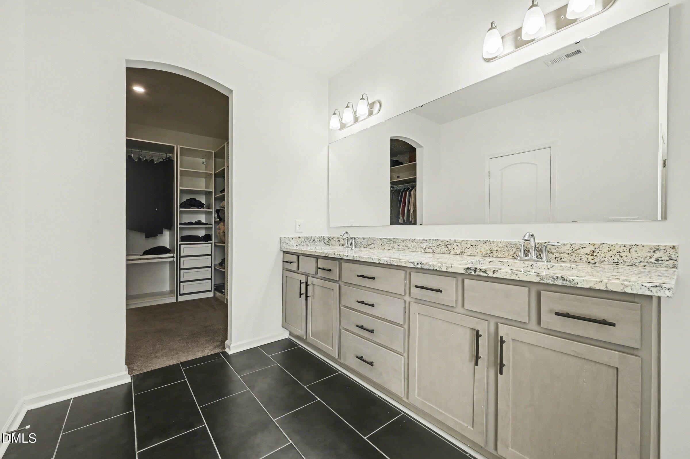 7015 Grainfield Road Mebane, NC 27302 - Photo 30 of 42 a bathroom with a granite countertop sink a mirror and a