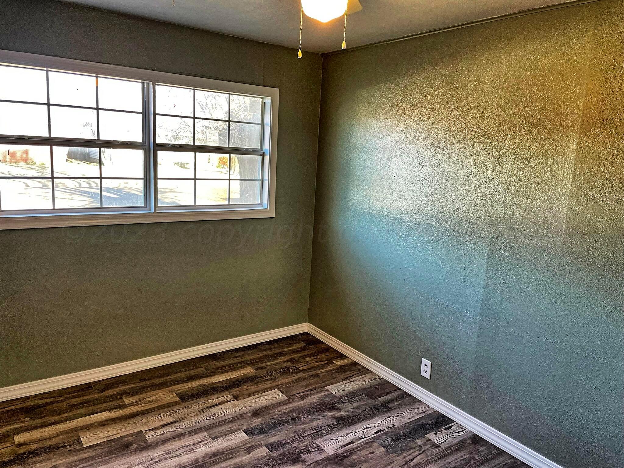 101 North Kentucky Street Perryton, TX 79070 - Photo 8 of 16 a view of a room with rack on the wall and a window