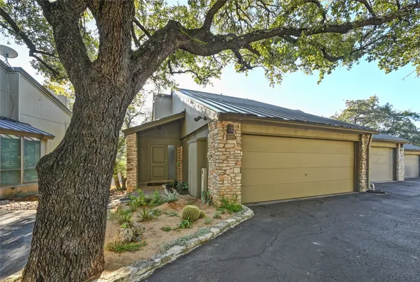a view of a house with a yard and tree