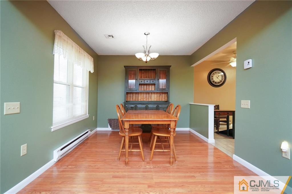 798 A Sparta Road Monroe Township, NJ 08831 - Photo 11 of 23 a dining room with a wooden table and chairs