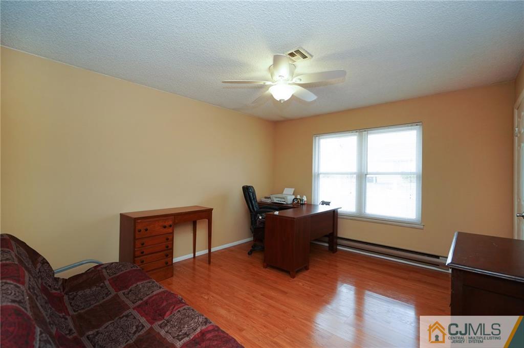 798 A Sparta Road Monroe Township, NJ 08831 - Photo 12 of 23 a bedroom with a bed and wooden floor