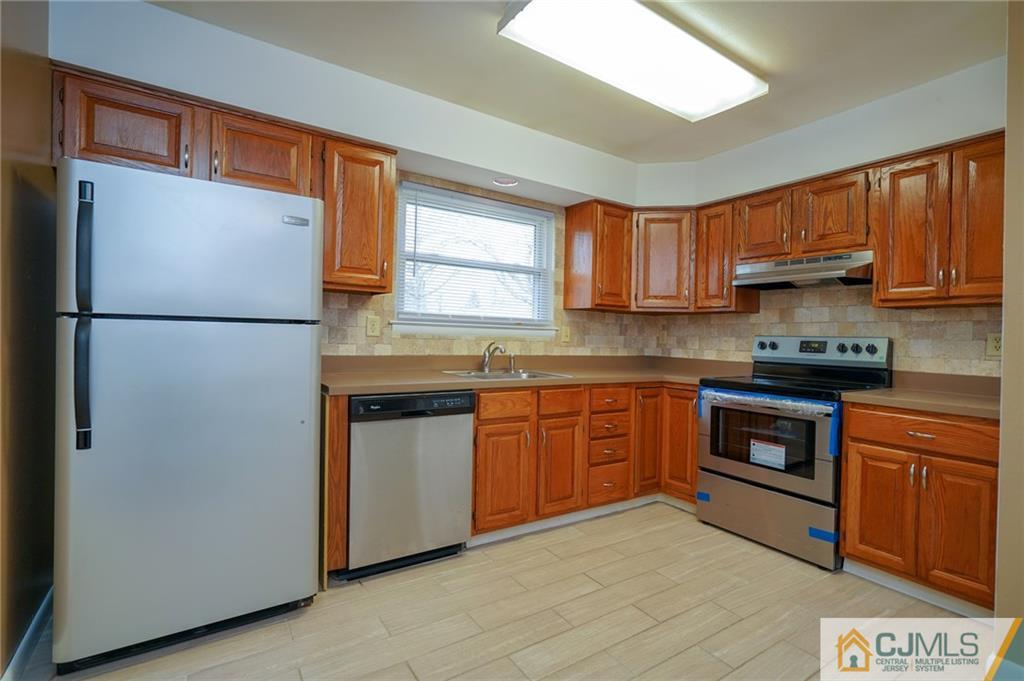 798 A Sparta Road Monroe Township, NJ 08831 - Photo 4 of 23 a kitchen with granite countertop a refrigerator stove top oven and sink