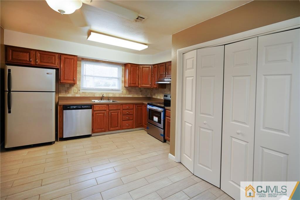 798 A Sparta Road Monroe Township, NJ 08831 - Photo 5 of 23 a kitchen with stainless steel appliances granite countertop a refrigerator and a stove top oven