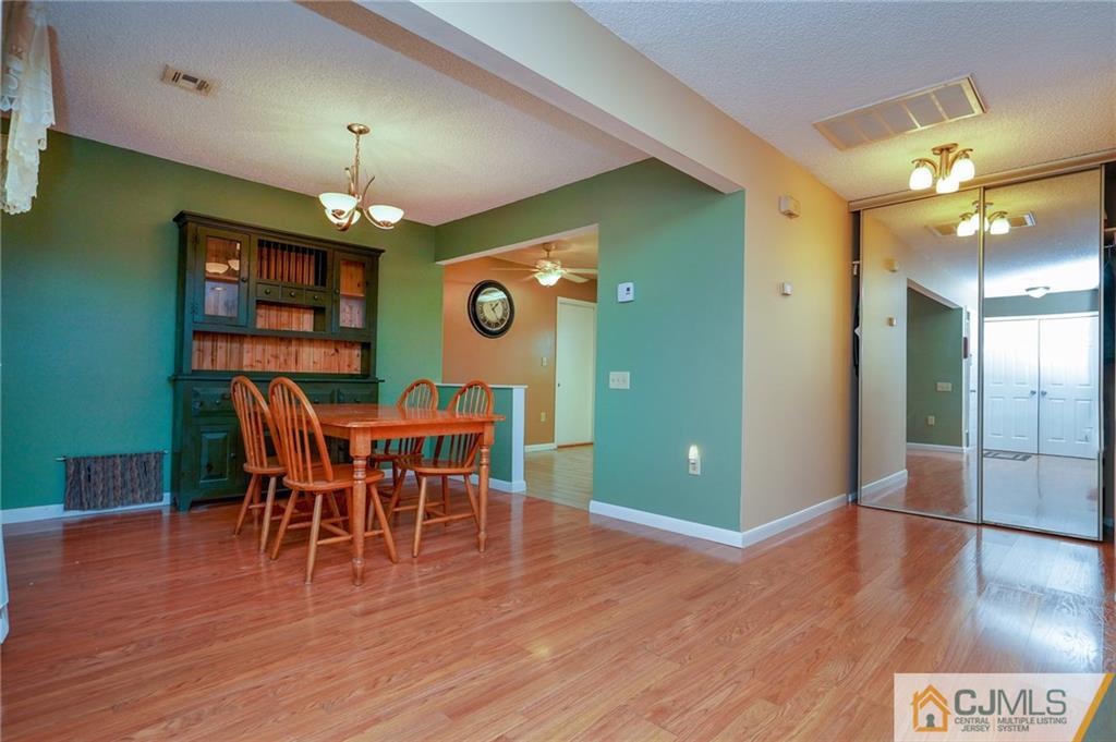798 A Sparta Road Monroe Township, NJ 08831 - Photo 10 of 23 a view of a dining room with furniture and wooden floor