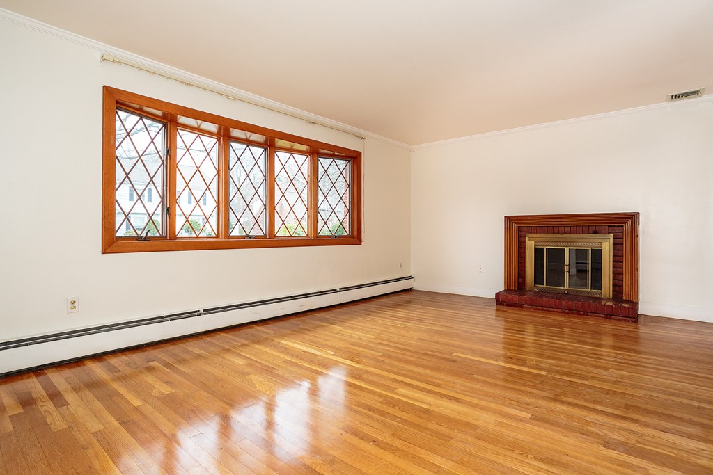 38 Taylor Road Belmont, MA 02478 - Photo 2 of 13 an empty room with wooden floor and windows