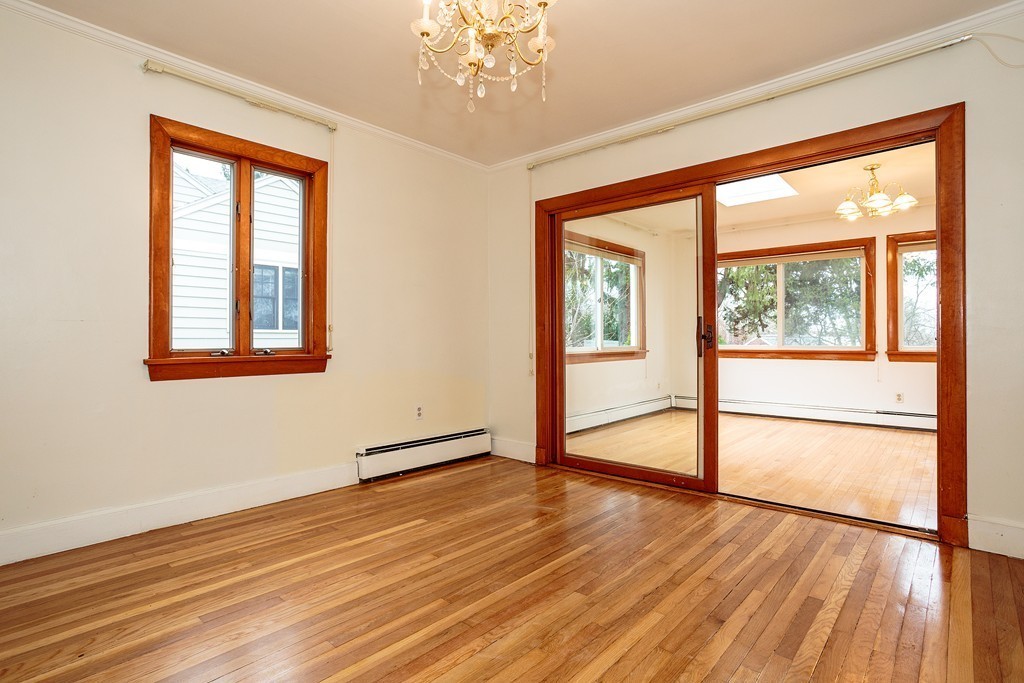 38 Taylor Road Belmont, MA 02478 - Photo 3 of 13 a view of an empty room with wooden floor and a window