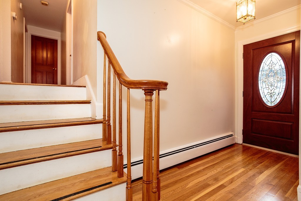 38 Taylor Road Belmont, MA 02478 - Photo 5 of 13 a view of a hallway with wooden floor and a hallway