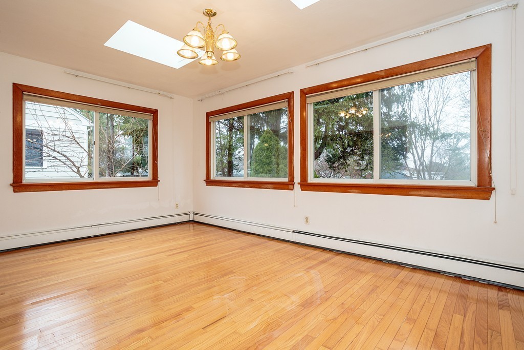 38 Taylor Road Belmont, MA 02478 - Photo 6 of 13 a view of an empty room with a window and wooden floor