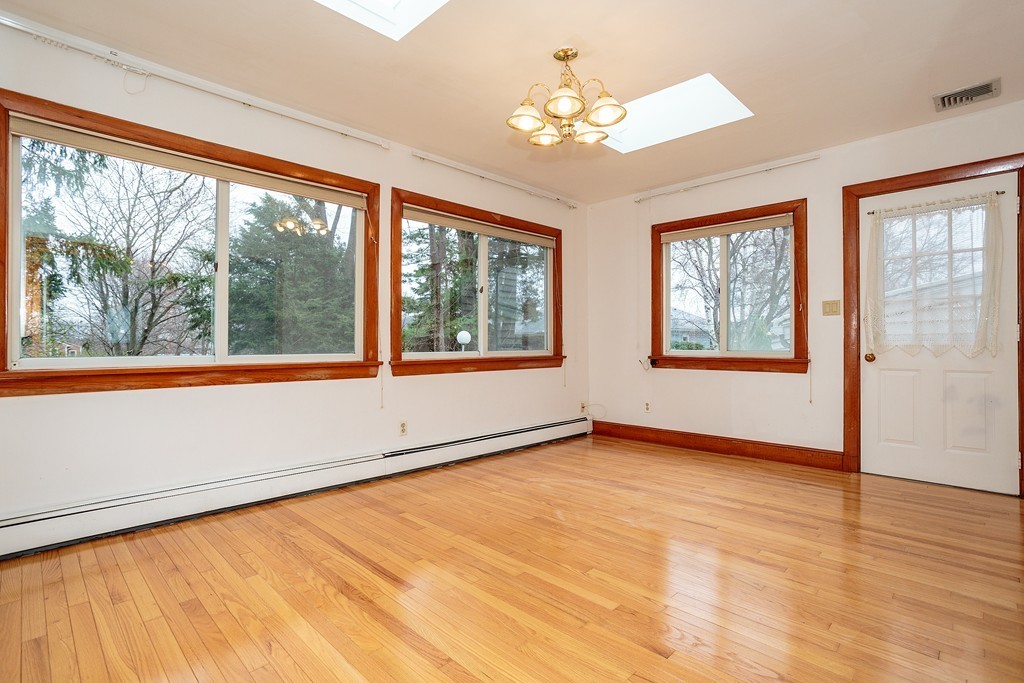 38 Taylor Road Belmont, MA 02478 - Photo 7 of 13 a view of an empty room with a window and wooden floor
