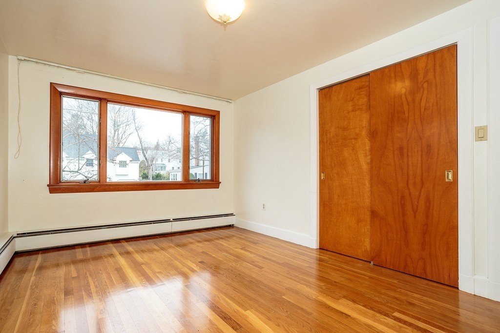 38 Taylor Road Belmont, MA 02478 - Photo 8 of 13 a view of an empty room with wooden floor and a window