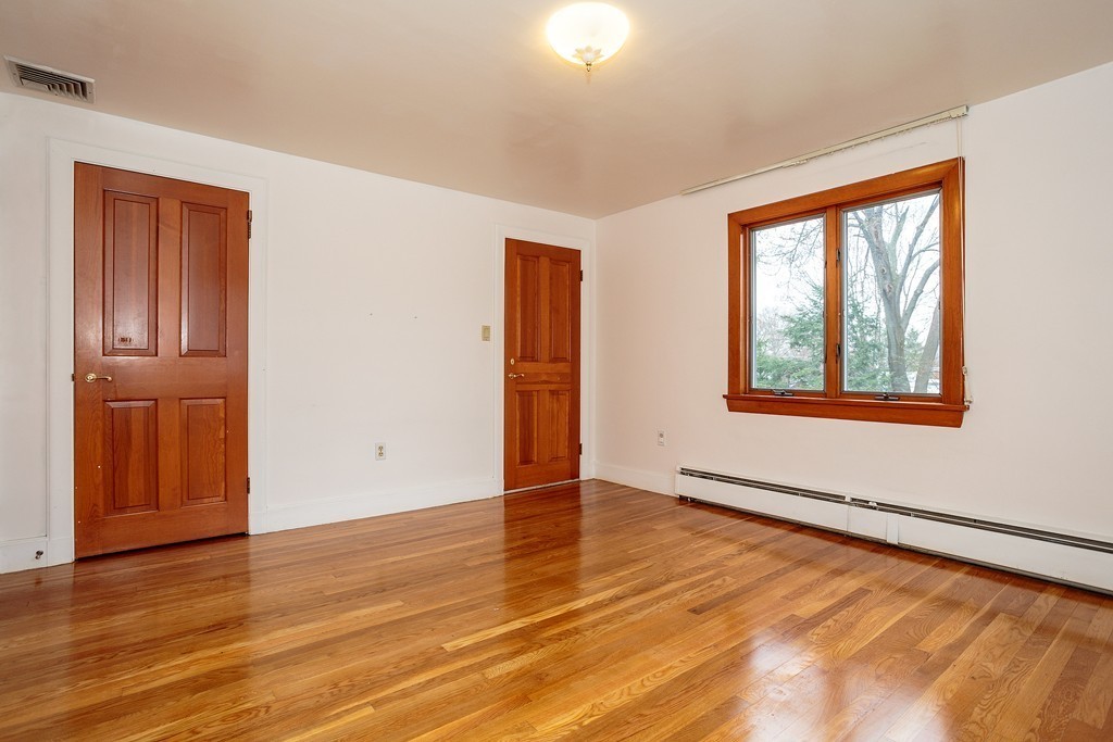 38 Taylor Road Belmont, MA 02478 - Photo 9 of 13 an empty room with wooden floor and windows