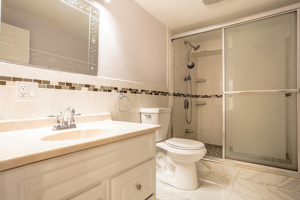 38 Taylor Road Belmont, MA 02478 - Photo 10 of 13 a bathroom with a sink toilet and shower