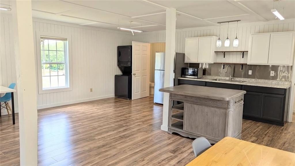 500 Coleman Mill Road Carrollton, GA 30116 - Photo 70 of 83 a kitchen with stainless steel appliances granite countertop a refrigerator a sink dishwasher a stove and white countertops with wooden floor