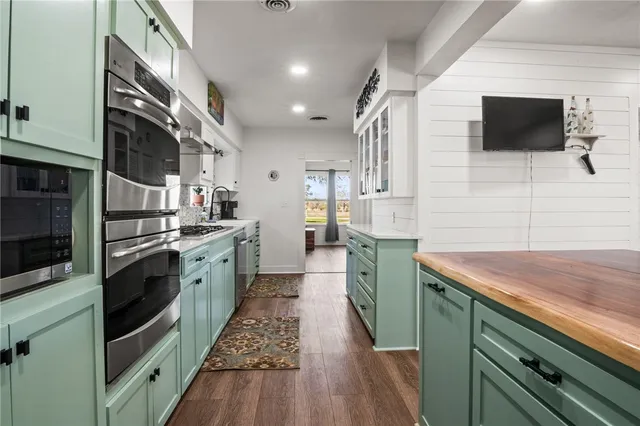 a kitchen with a sink and a stove top oven