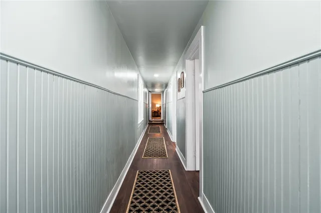 a view of hallway with wooden floor