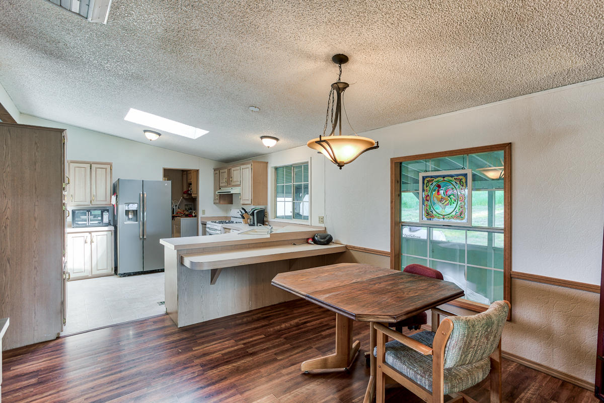 19555 Live Oak Road Red Bluff, CA 96080 - Photo 18 of 35 a view of a dining room with furniture window and wooden floor