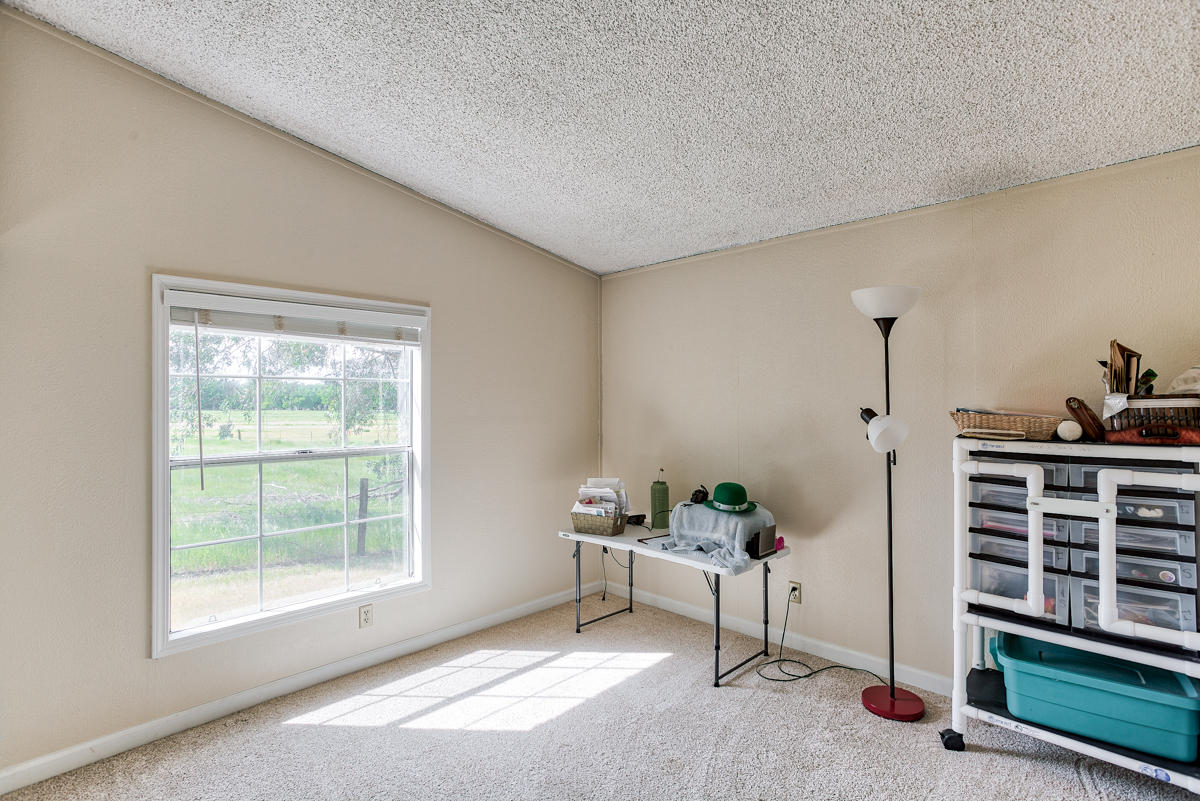 19555 Live Oak Road Red Bluff, CA 96080 - Photo 23 of 35 a living room with furniture a window and a potted plant