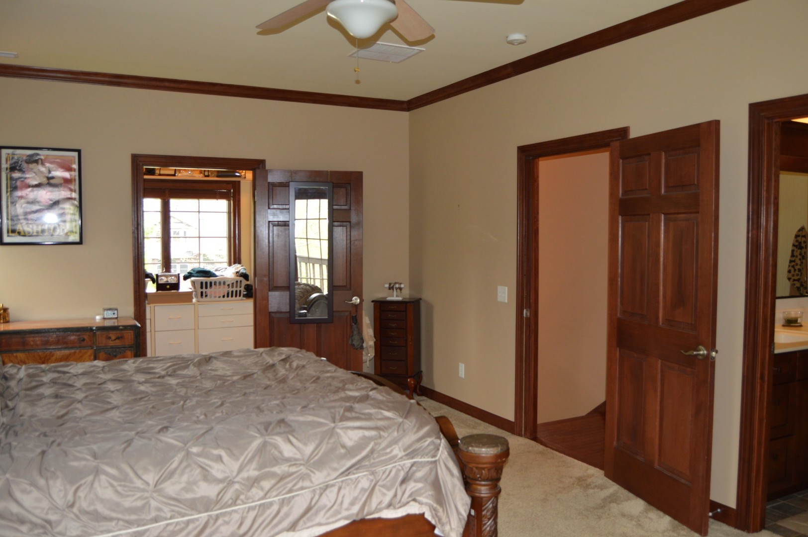 9482 Abbey Way Downs, IL 61736 - Photo 35 of 93 a bedroom with a large bed and a chandelier