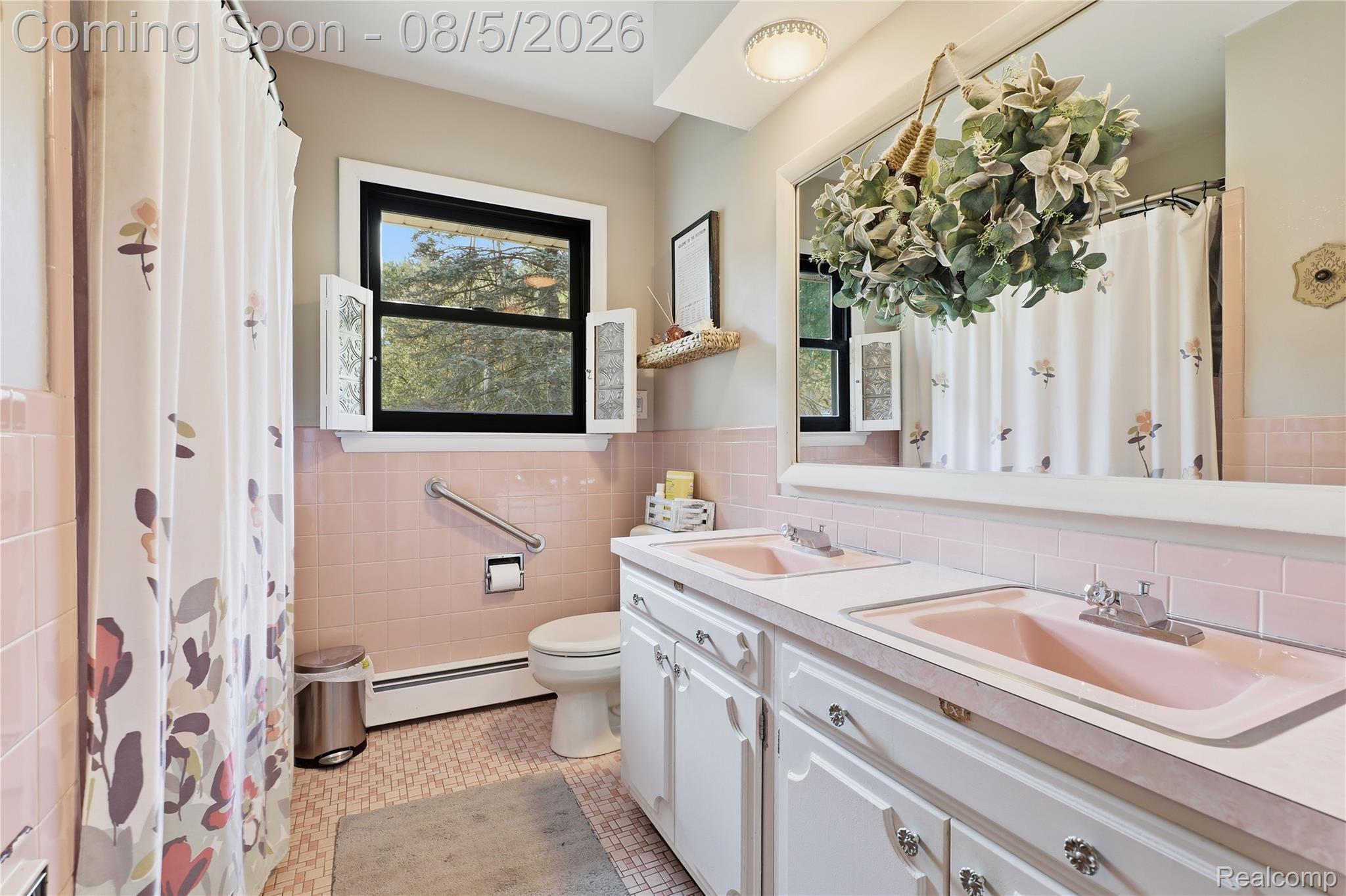 6478 West Stanley Road Mount Morris, MI 48458 - Photo 43 of 80 Double vanity with pink sinks, white cabinetry, and polished chrome hardware