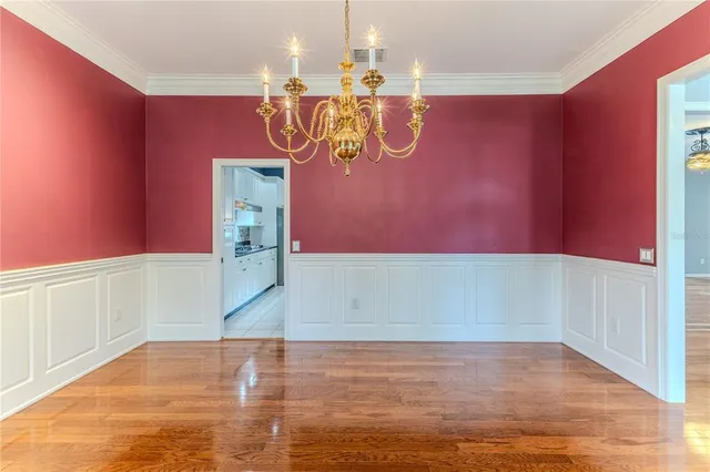 a view of empty room with wooden floor and fireplace