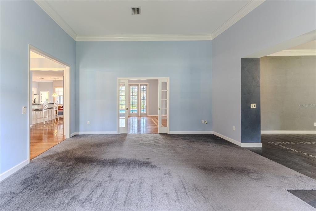 7512 Oak Tree Lane Spring Hill, FL 34607 - Photo 20 of 89 an empty room with wooden floor and windows